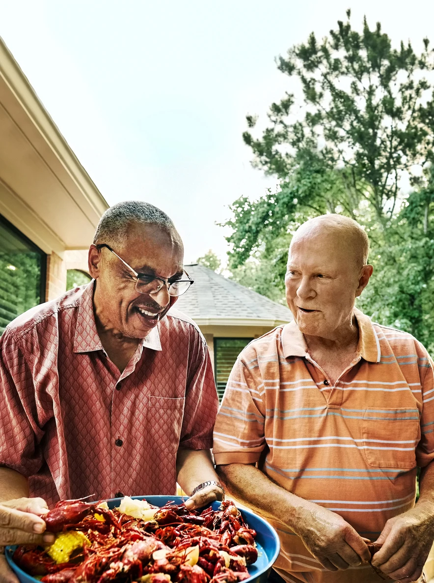 assisted living residents in Maryville TN holding a plate of cooked crayfish